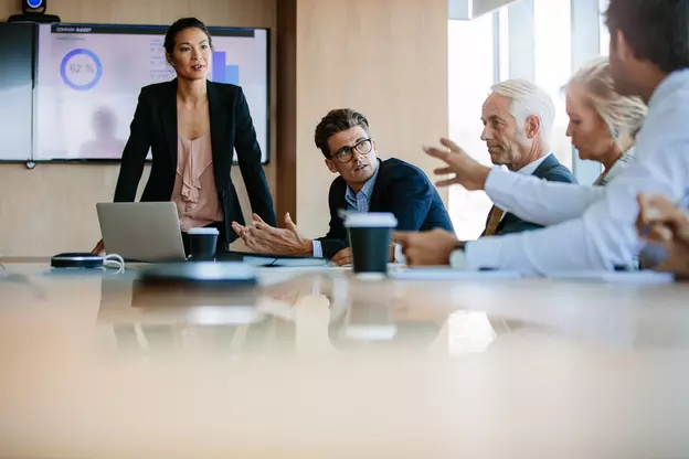 business woman doing presentation with a man asking a question