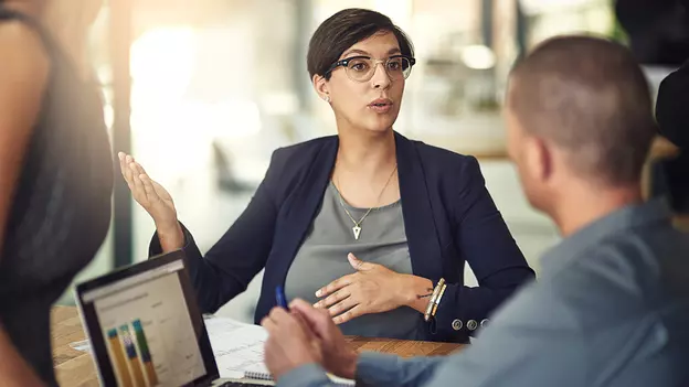 business professionals working at table together