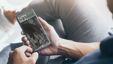 person looking at world tax journal on phone